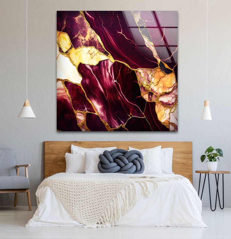 a bedroom with a bed and a painting on the wall