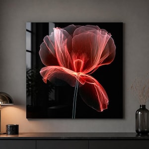 May include: A square wall art piece featuring a high-contrast, translucent red poppy flower against a solid black background. The petals appear delicate and layered with a glowing effect, centered above a thin, dark, vertical stem.