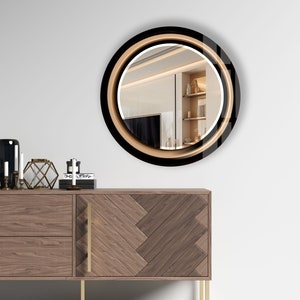 a round mirror on a wall above a dresser