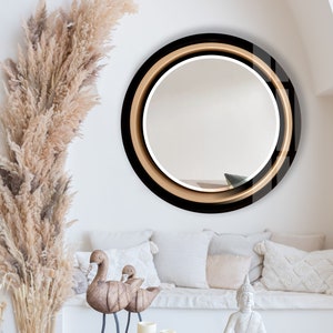 a living room filled with furniture and a round mirror