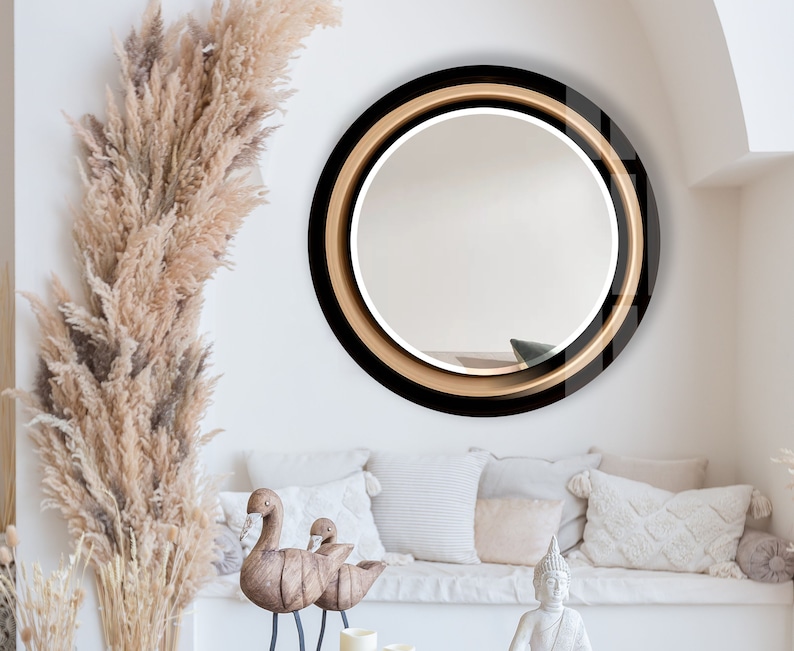 a living room filled with furniture and a round mirror