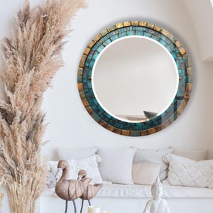 a living room filled with furniture and a round mirror