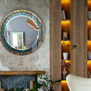 a living room with a fireplace and a round mirror