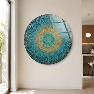 May include: A large circular wall art piece featuring a radial pattern of textured brushstrokes in shades of deep teal, turquoise, and metallic gold. The design radiates from a central point, creating a sense of movement and depth across the surface.