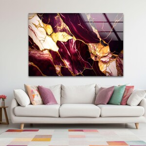 a living room with a couch and a painting on the wall
