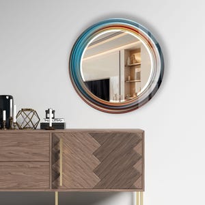 a round mirror on a wall above a dresser