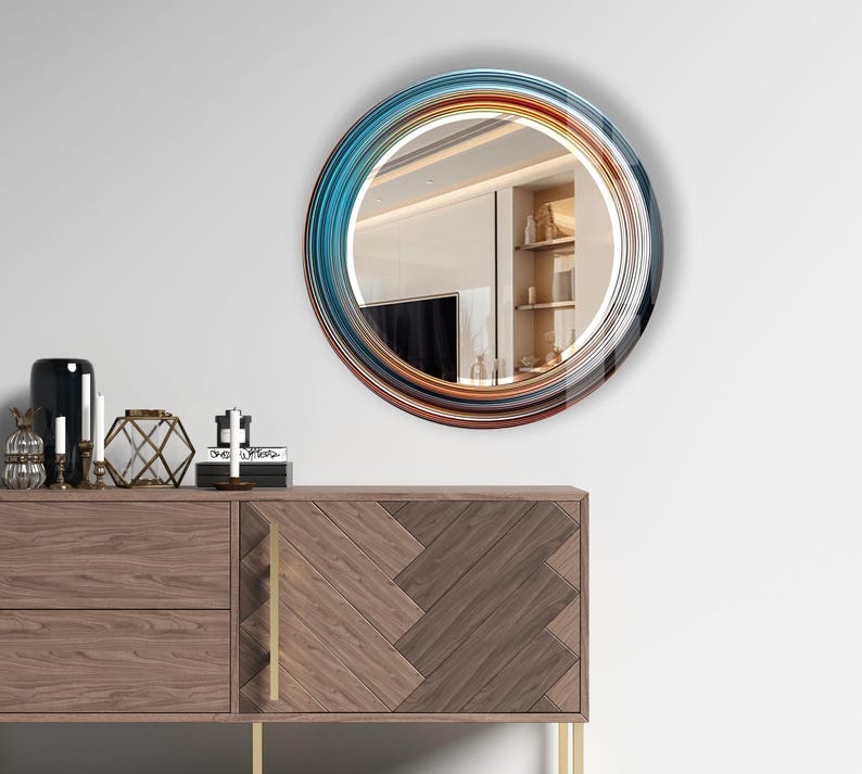 a round mirror on a wall above a dresser