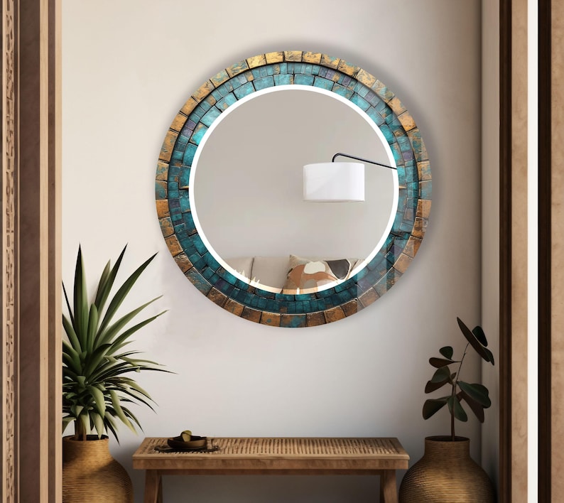 a round mirror on a wall above a table
