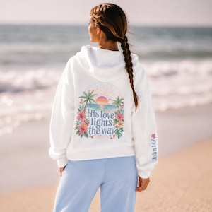 Jesus Love Theme Teenage Gift Bible Verse Hoodie Christian Women Faith Inspired Pullover Sweatshirt Teen Girl Youth Group Shirt Religious Camp Apparel Ocean Tropical Sunrise Scene Palm Tree Design His Love Lights Way Back Text John Verse