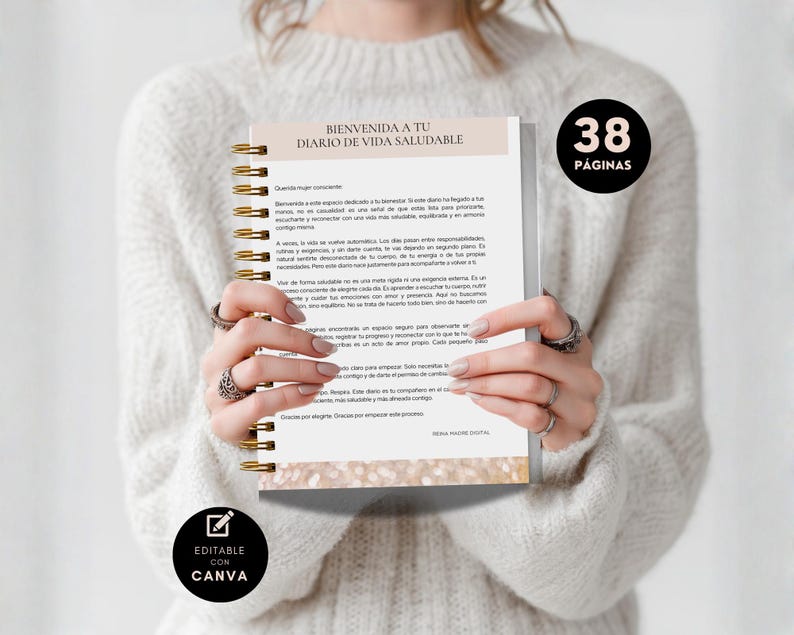 May include: A spiral-bound notebook with gold-colored coils is held open, displaying text in Spanish. The cover reads "BIENVENIDA A TU DIARIO DE VIDA SALUDABLE." A black circle with "38 P&Aacute;GINAS" is visible. The notebook is "EDITABLE CON CANVA."