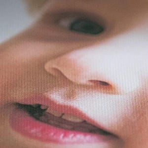 A close-up of a child's face, focusing on their lips and nose.