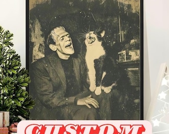 May include: Black framed print featuring a sepia-toned image of Frankenstein laughing with a black and white cat. The cat is also mid-laugh, with its mouth wide open. The word "CUSTOM" is printed in red across the bottom of the image.