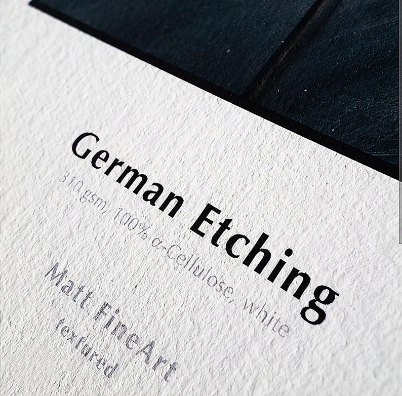 The image is a close-up of a white surface with text and a black border.