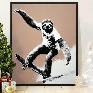 May include: Black and white framed print of a sloth skateboarding. The sloth is wearing a white t-shirt with the word "Wizard" on it. The background is a solid light brown color.