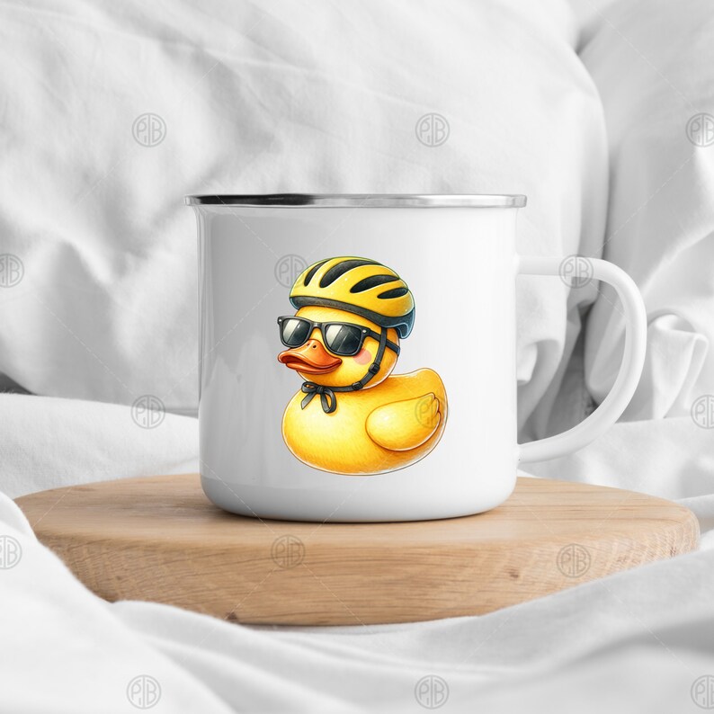 May include: White enamel mug with a yellow rubber duck wearing a black helmet and sunglasses. The duck is wearing a black bow tie.