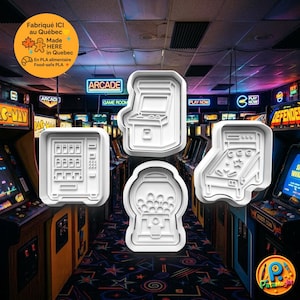 May include: Four white plastic cookie cutters shaped like arcade game machines, including a gumball machine, a pinball machine, and a classic arcade cabinet. The background is a colourful arcade.