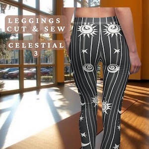 May include: Black leggings with a white celestial print featuring moons, stars, and suns. The leggings have a stripe pattern and are made for comfort and style.