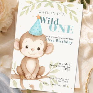 May include: A rectangular birthday invitation card featuring a watercolour illustration of a brown monkey wearing a blue polka-dot party hat. The text reads: Waylon is a Wild One, Join Us to Celebrate His First Birthday, Saturday November 20 2PM.