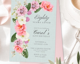 May include: A rectangular birthday invitation card with a light blue textured background, featuring a floral arrangement of pink and white flowers on the left side. The text reads: Eighty Years Loved, Join Us to Celebrate Carol's 80th Birthday, November 20, Saturday, 6 PM, The Garden Room, 100 First Avenue, Your Town, RSVP to Vicki 000.123.4567.