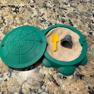 Mini turtle sandbox with kinetic sand. Includes mini bucket and shovel!