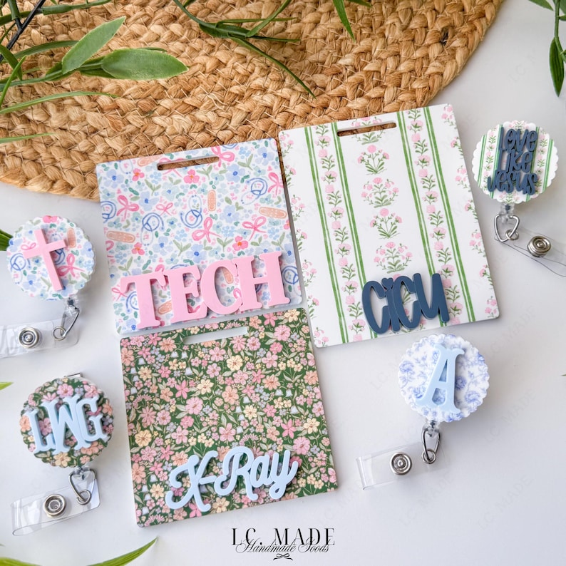 May include: A collection of floral and patterned badge reels and ID holders. The badge reels feature a cross, the letters LMG, and the words "LIVE LIKE JESUS". The ID holders have the words TECH, X-Ray, and CCU.