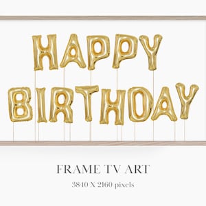 Peut inclure: Une impression encadrée avec les mots "Happy Birthday" écrits en ballons dorés sur fond blanc.