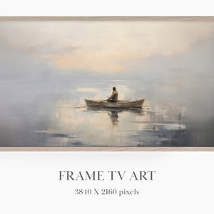 Puede incluir: Una pintura de una persona remando en un bote en un lago tranquilo con un cielo brumoso. La pintura está enmarcada en un marco de madera claro.