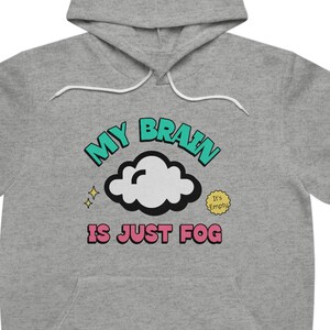 May include: A gray hoodie with a graphic print of a cloud with the text "My Brain is Just Fog" in turquoise, pink, and yellow.