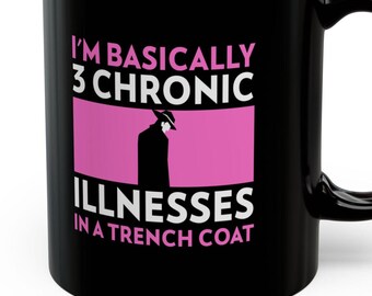 May include: Black coffee mug with white text that reads "I'm basically 3 chronic illnesses in a trench coat". The text is in a pink rectangle with a black silhouette of a person in a trench coat and hat inside.