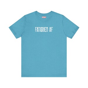 Fatigued AF Tshirt So Tired Funny Chronic Fatigue Syndrome light blue tee for Chronic Illness MECFS Tees with white lettering that says fatigued af