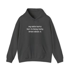 My Ankle Hurts But Im Being Really Brave About It hoodies Funny Injuries Sprains Twisted Broken Ankles Humor grey hooded sweatshirts White Lettering
