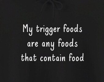 May include: Black hoodie with white text that reads "My trigger foods are any foods that contain food."