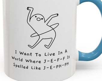 May include: White ceramic mug with a blue handle. The mug features a line drawing of a stick figure doing a hula hoop routine. The text on the mug reads "I Want To Live In A World Where J-E-F-F Is Spelled Like J-E-PH-PH".
