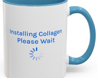 May include: White ceramic mug with a blue rim and handle. The mug has a blue graphic that says "Installing Collagen Please Wait" with a blue loading icon.