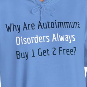 May include: Light blue hoodie with the text "Why Are Autoimmune Disorders Always Buy 1 Get 2 Free?" printed on the front.