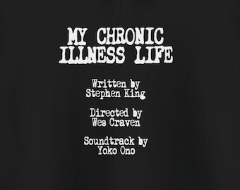 May include: Black hoodie with white text that reads "MY CHRONIC ILLNESS LIFE" and includes the following credits: "Written by Stephen King", "Directed by Wes Craven", and "Soundtrack by Yoko Ono".