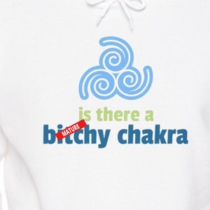 May include: White hoodie with a blue and green graphic design. The design includes a stylized swirl pattern and the text "is there a bitchy chakra" with a "mature" sticker.