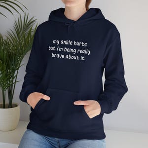 My Ankle Hurts But Im Being Really Brave About It hoodies Funny Injuries Sprains Twisted Broken Ankles Humor navy blue hooded sweatshirts White Lettering