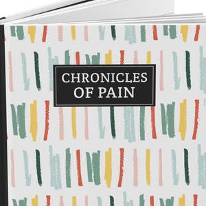 Chronic Pain Journal  Chronicles of Pain Hardcover Lined Journal for Spoonies Medical Planner a journal book with abstract lines in different colors with black box and binding in white lettering chronicles of pain