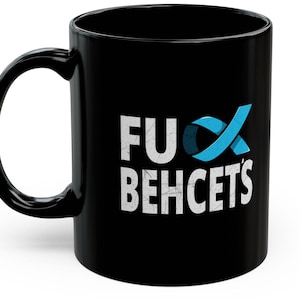 May include: Black coffee mug with a white graphic that says "F**k Behcet's" with a blue ribbon design.