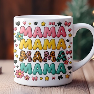 May include: White ceramic mug with a colorful design featuring the word "MAMA" repeated four times in different styles. The design includes stars, hearts, bows, and flowers.