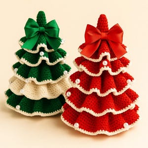 May include: Two handmade crochet Christmas trees. One is green and cream with a green bow, the other is red with a red bow. Both trees are decorated with white trim and small white beads. The trees are a festive holiday decoration.
