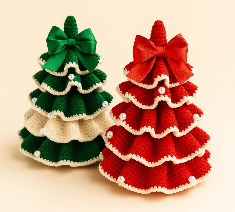 May include: Two handmade crochet Christmas trees. One is green and cream with a green bow, the other is red with a red bow. Both trees are decorated with white trim and small white beads. The trees are a festive holiday decoration.