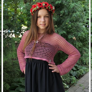 May include: A young person wearing a pink crocheted top with long sleeves and a black skirt. They are wearing a flower crown with red flowers.
