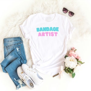 Bandage Artist Vet Medicine T-Shirt | Vet Tech|  Vet Student Gift | Veterinary Apparel |  Veterinarian Gift | Unisex Jersey Short Sleeve Tee