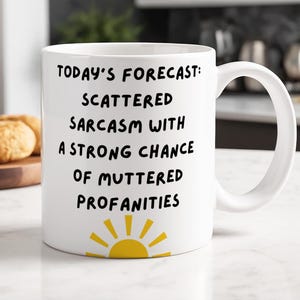 May include: White ceramic mug with the text "TODAY'S FORECAST: SCATTERED SARCASM WITH A STRONG CHANCE OF MUTTERED PROFANITIES" in black. A yellow sun graphic is at the bottom. The mug has a large handle.
