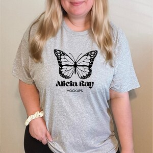 May include: A heather gray t-shirt with a black butterfly graphic and the text "Alicia Ray Mockups".