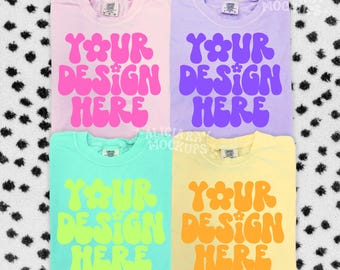May include: Four t-shirts in pastel colors: pink, purple, teal, and yellow. Each shirt features the text "YOUR DESIGN HERE" in a retro font. The shirts are displayed on a black and white polka dot background.