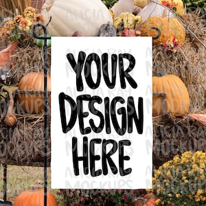 May include: A white sign with the text "Your Design Here" in black lettering, displayed in front of a fall-themed backdrop of pumpkins, gourds, and hay bales.