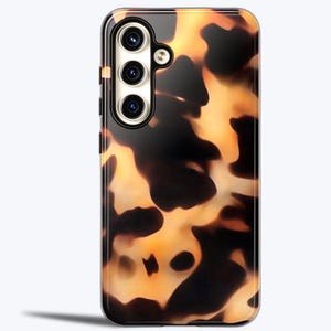 May include: A phone case with a tortoiseshell pattern. The case has a black background with brown and orange swirls. The case has a camera cutout on the back.